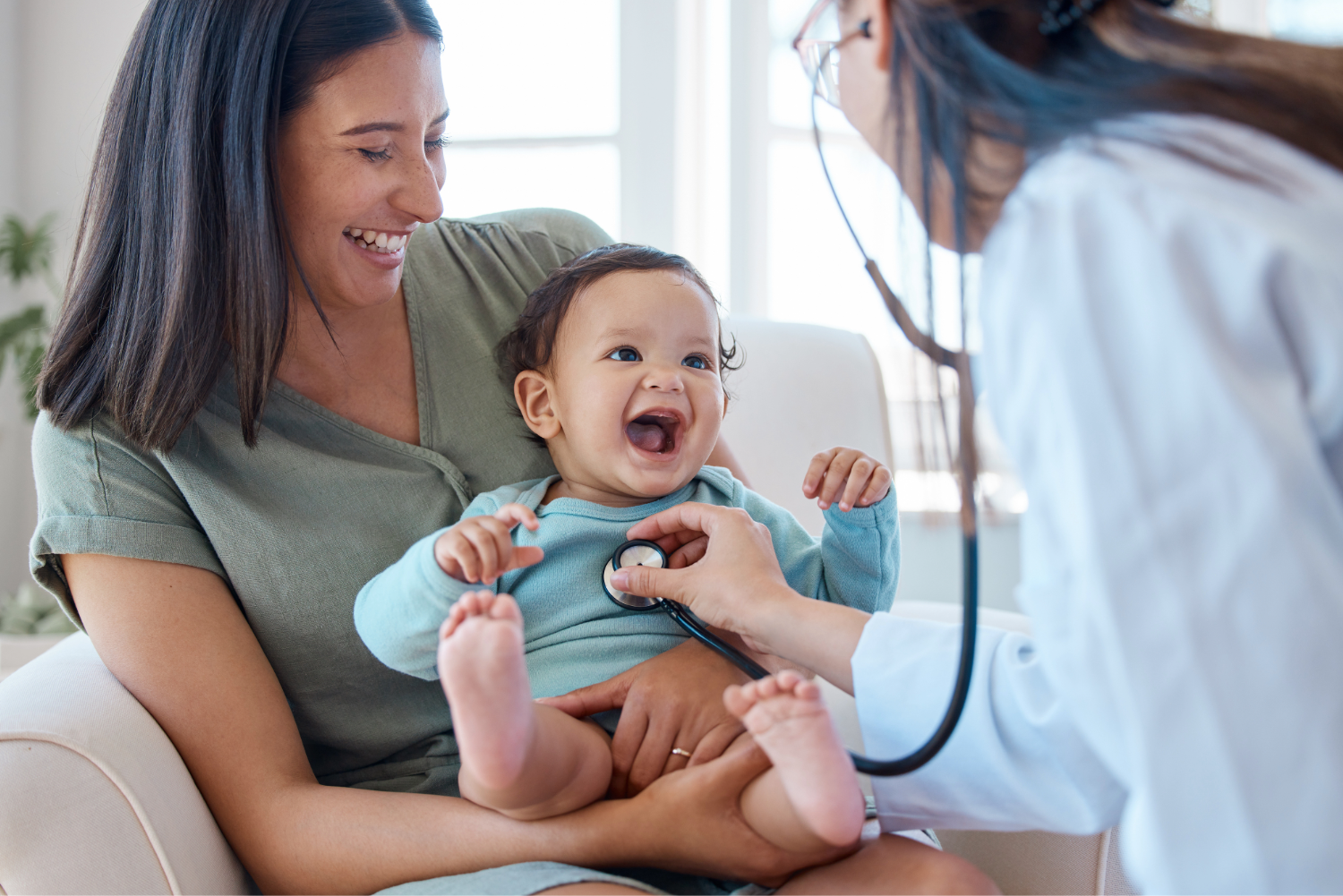 Baby smiling at doctor