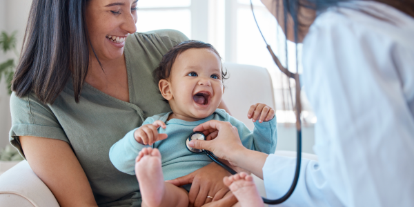 Baby smiling at doctor